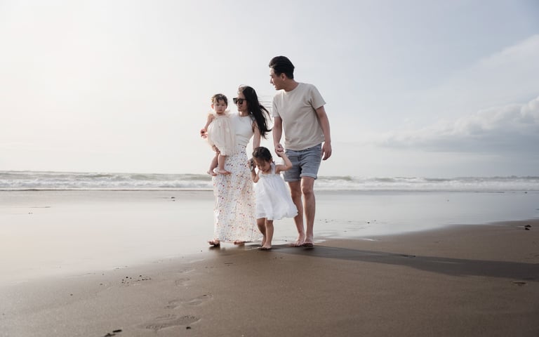Family enjoying a relaxed walk along Petitenget Beach Seminyak Bali during a natural family photo session