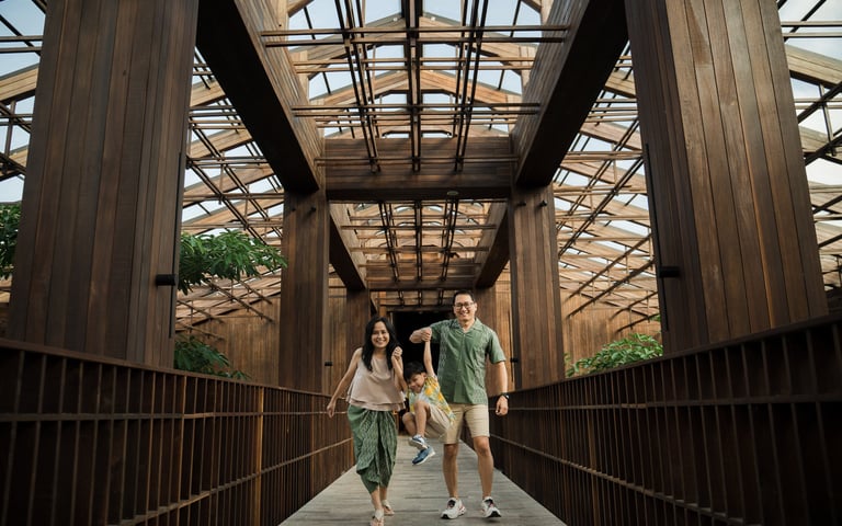 Parents and children walking across modern walkway at The Meru Sanur Bali family photo session