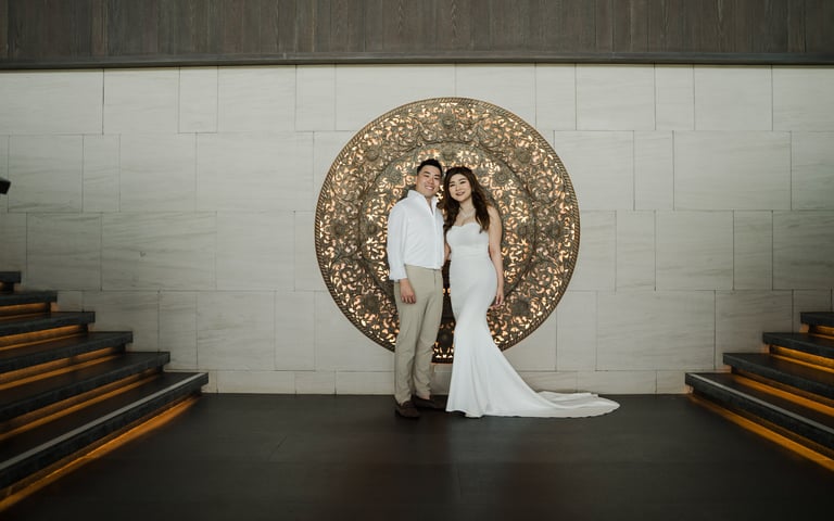 Couple portrait during a prewedding photoshoot at the grand staircase of Apurva Kempinski Bali resort