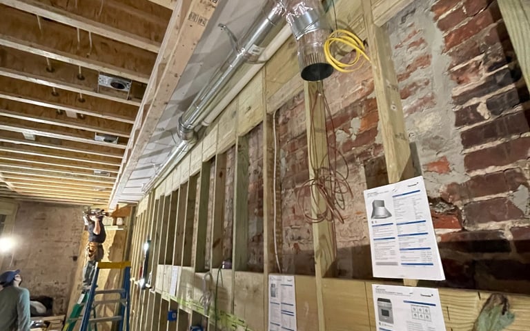 a man standing in a room with a ladder and a ladder