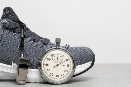 a stopwatch watch and a sneaker