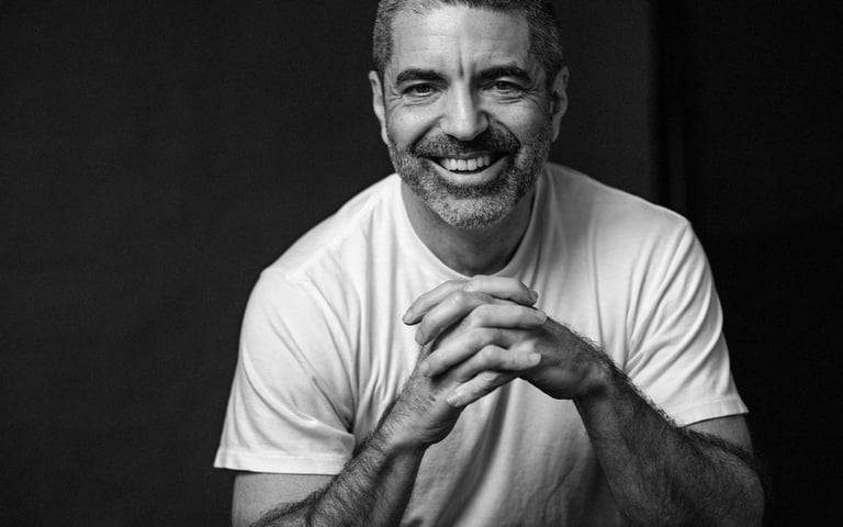 a man with a beard and a white shirt