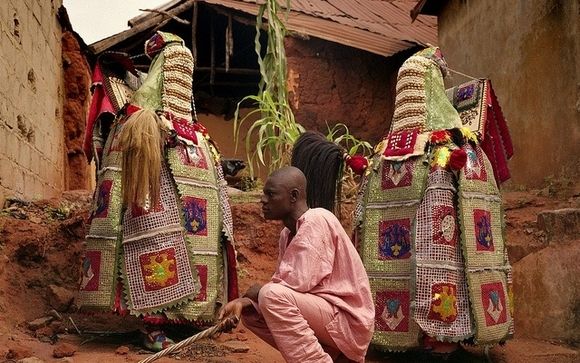 Egungun Society Chief kneels at Ancestors feet at Oyotunji African kingdom