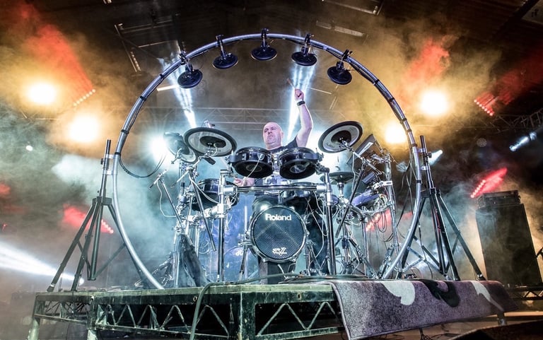 a drum kit with a circular rig on stage