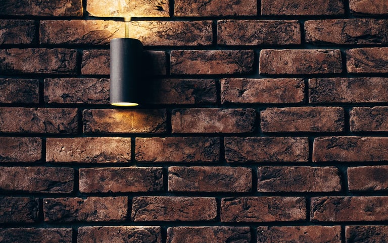 a brick wall with a light installed by pbp services in worcester