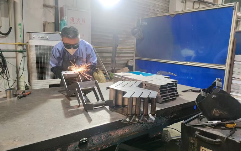 Professional welder in safety gear welding custom metal components