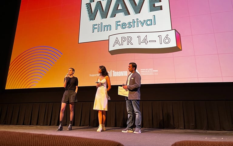 three people standing on a stage 
