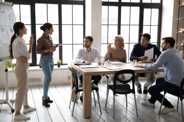 A group of people discussing work at a table.