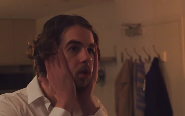 a man with a beard and a white shirt
