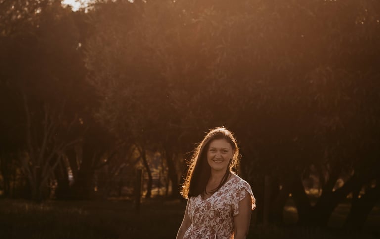 a woman in a dress standing in a field