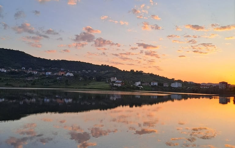 a lake with a bench and a bench in the foreground