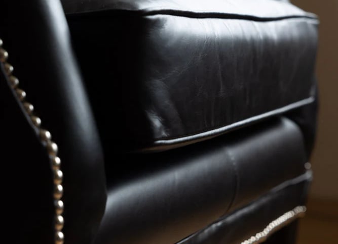 black leather armchair with decorative nails