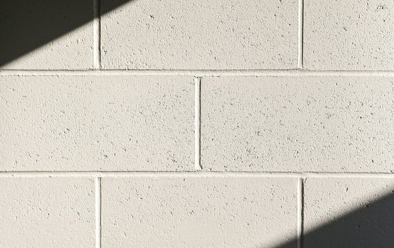 White concrete block wall with diagonal shadows.