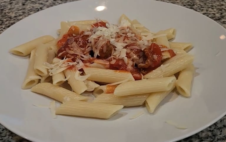 a plate on a counter with noodles with sauce