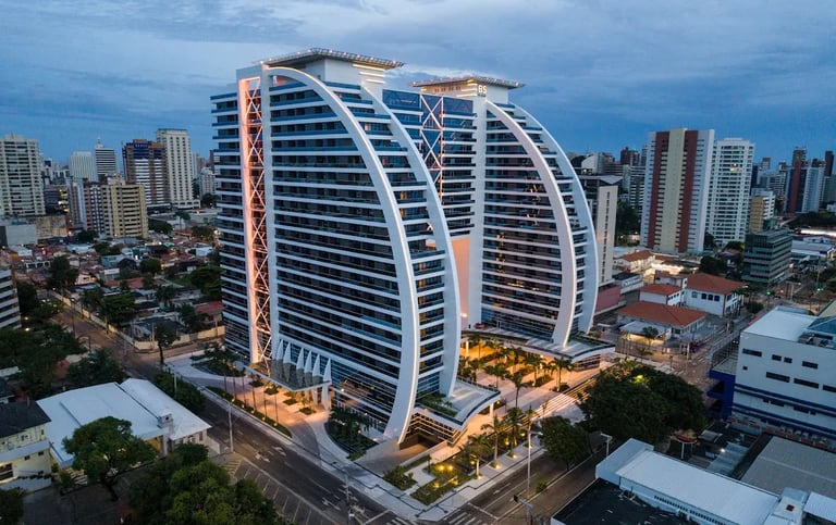 Modern luxury high-rise architecture of BS Design Corporate Towers in Fortaleza city skyline at twilight.