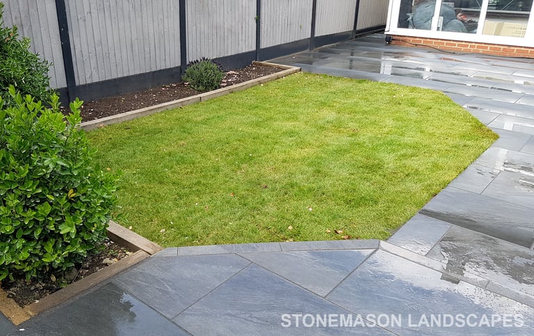 Grey sandstone circle paving slabs with charcoal edging