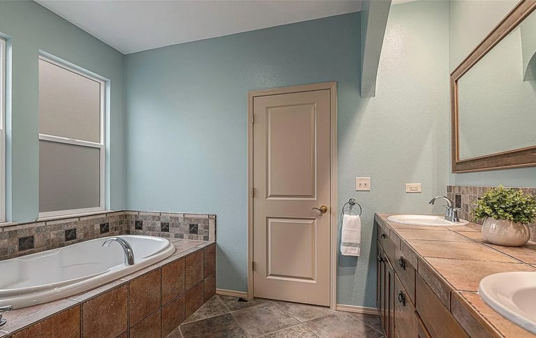 a bathroom with a tub and a large tub