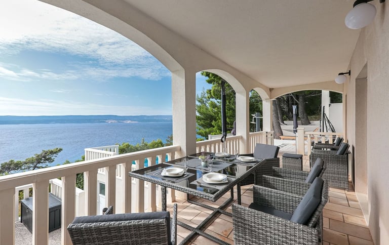 The photo shows an apartment balcony and a part of the pool. 
