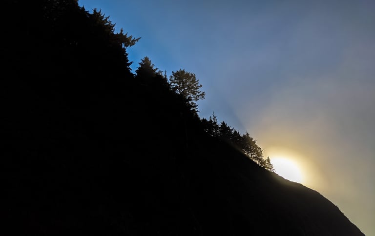 The sun peaks over the ridge in the coastal range of Oregon.