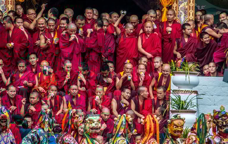 Masked-dancer-with-Monks-in-The-Backdrop-in-Thimphu