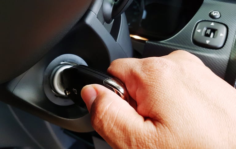 a person's hand is pressing a push start button on a car