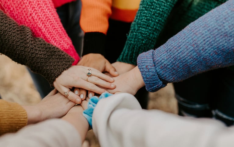 a group of people holding hands together for collaboration from ededge