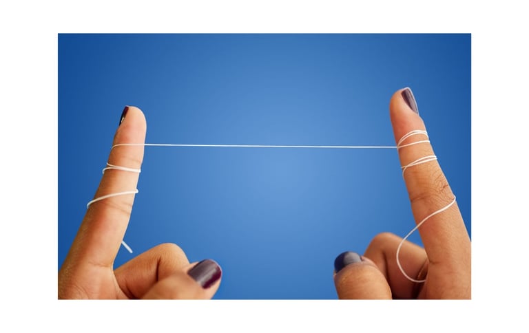 a person's fingers wrapped with a string of dental floss