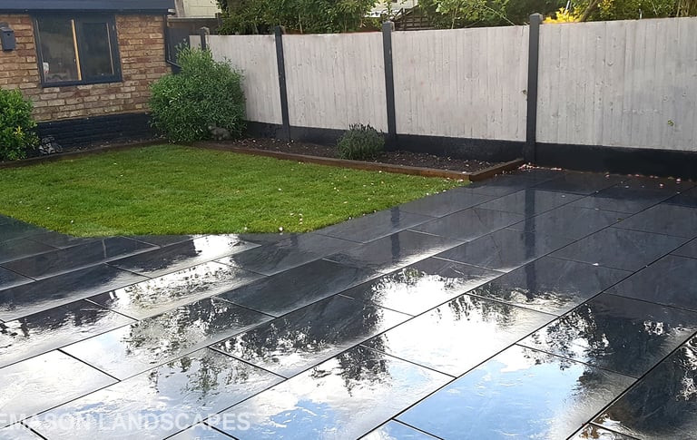 Grey sandstone circle paving slabs with charcoal edging