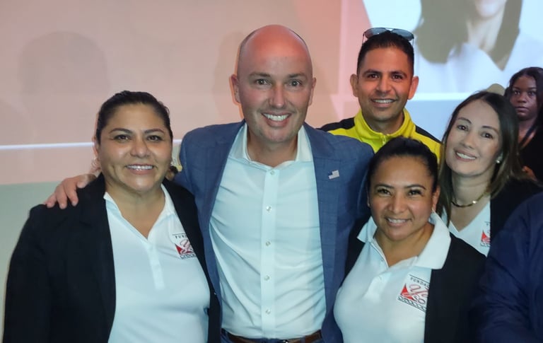 A group of professionals smiling together at a business networking event conference.