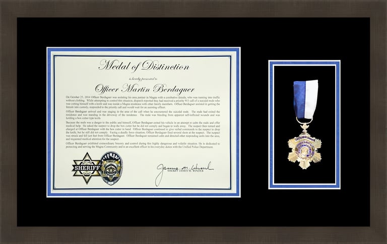 Framed Medal of Distinction award certificate and gold star medal for Officer Martin Berdaquer.