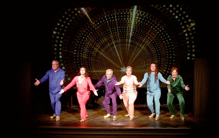 A diverse cast of tap dancers in colorful tracksuits performing the final of Alive and Kicking