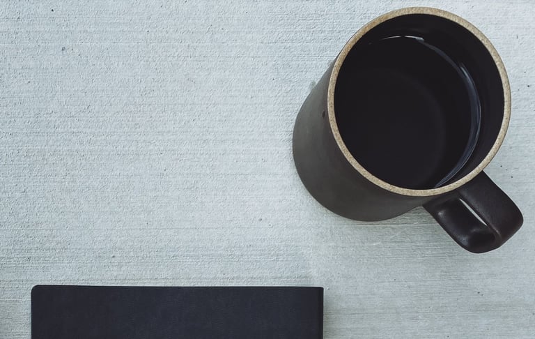 journal, journal sleeve and cup of coffee