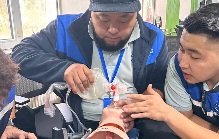 an ambulance driver ventilating a baby model
