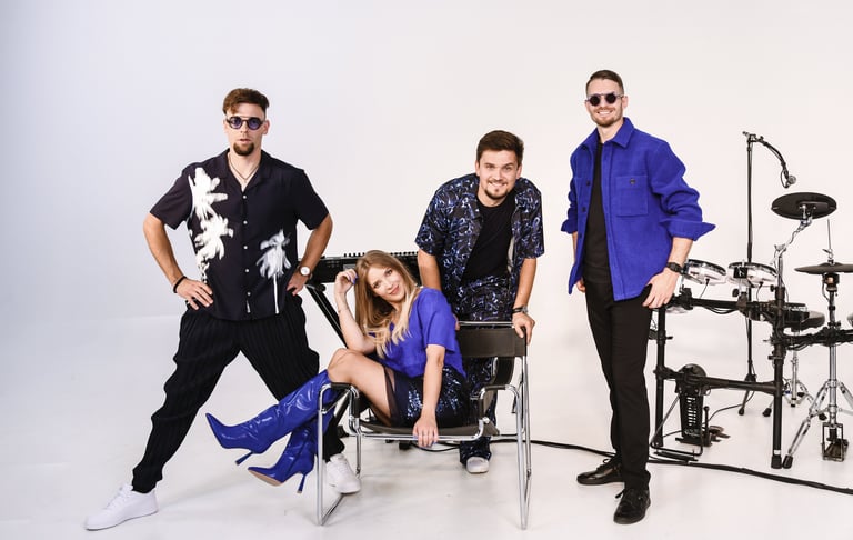 a group of performers standing around a drum set up