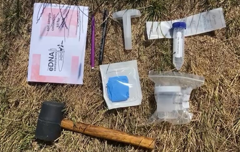 eDNA water filtration kit components including tubes, filters, syringes, parafilm, and a caulking gun, laid out on grass for