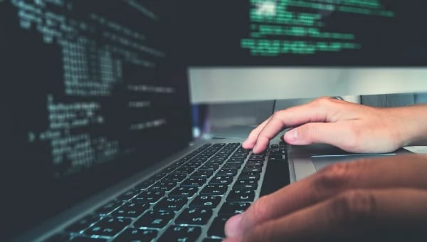 Developer actively coding on laptop