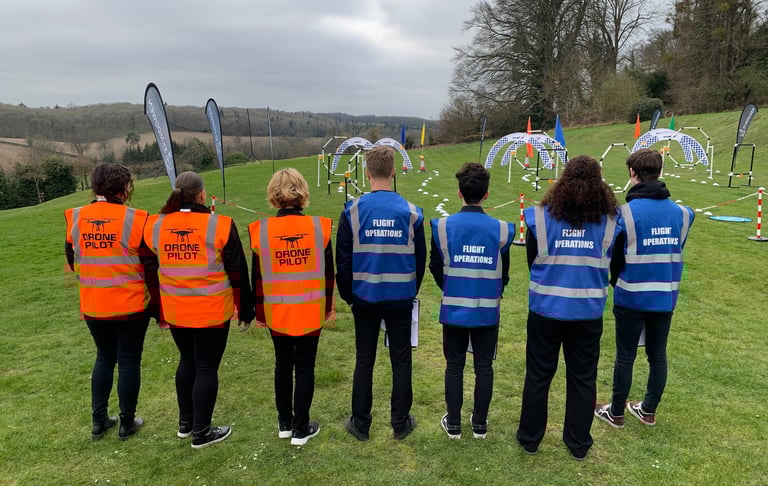 a group of people in safety vests standing in a field