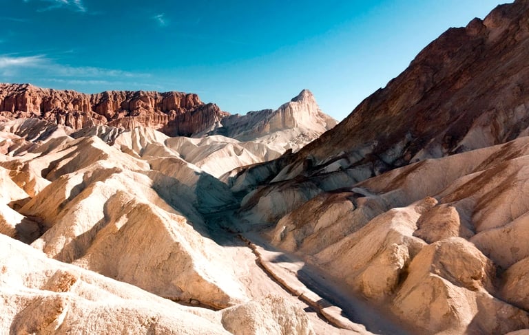 Death Valley, CA - Red Cathedral Mountains in the distance beyond Golden Canyon mountains