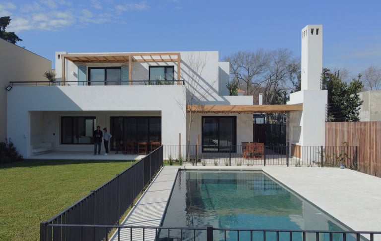 a house with a pool and a pool in the yard