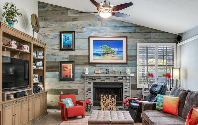 Faux barnwood shiplap mural in blues, greys, creams matching a tiled fireplace.
