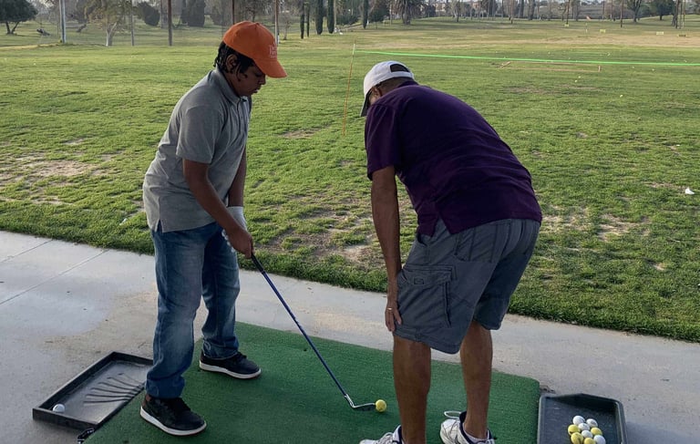 Enhancing Forward Action Inc. image young golfer being taught golf