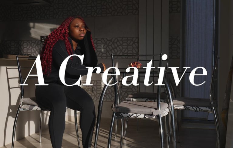 a picture of a girl with dark red hair sitting down in a video production