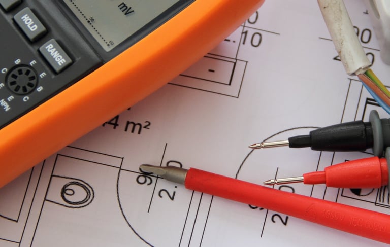 An electrical multimeter on top of building design drawings