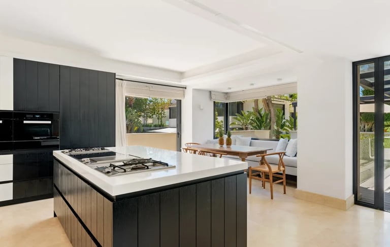 Bright kitchen with garden views and dining area at Villa El Olivo, Marbella