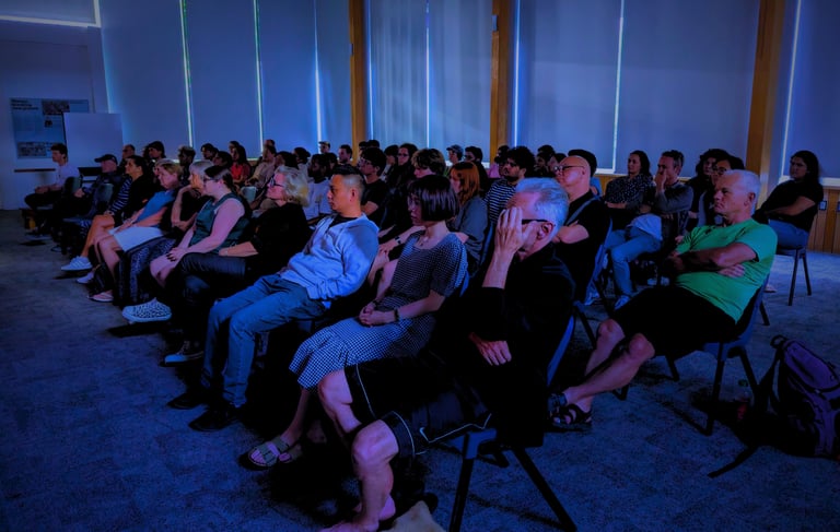 Audience immersed in a movie screening hosted by the Auckland International Film Club.