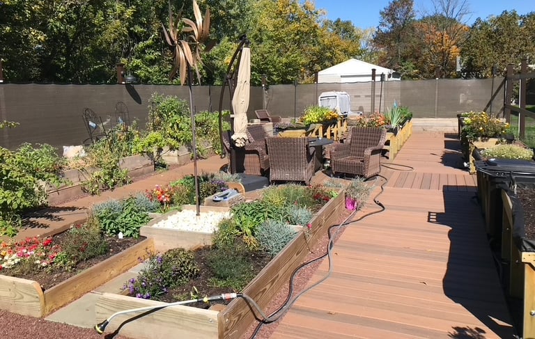 Outdoor raised bed garden with composite decking and mesh fencing by Golden Rule Construction