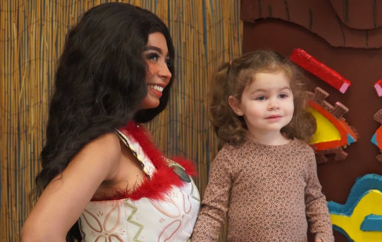 Moana poses with a child at a meet and greet