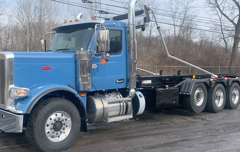 blue Peterbilt roll-off truck