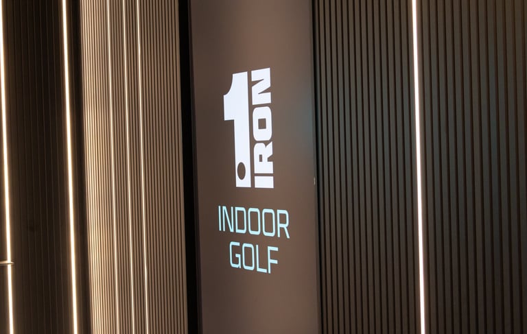 The foyer and video screen of 1IRON indoor golf simulator venue