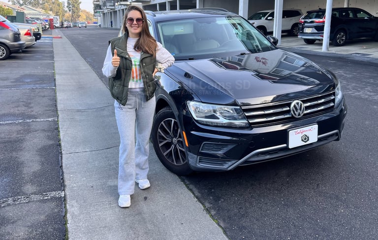 Girl standing in front of volkswagen Tiguan 2019 car